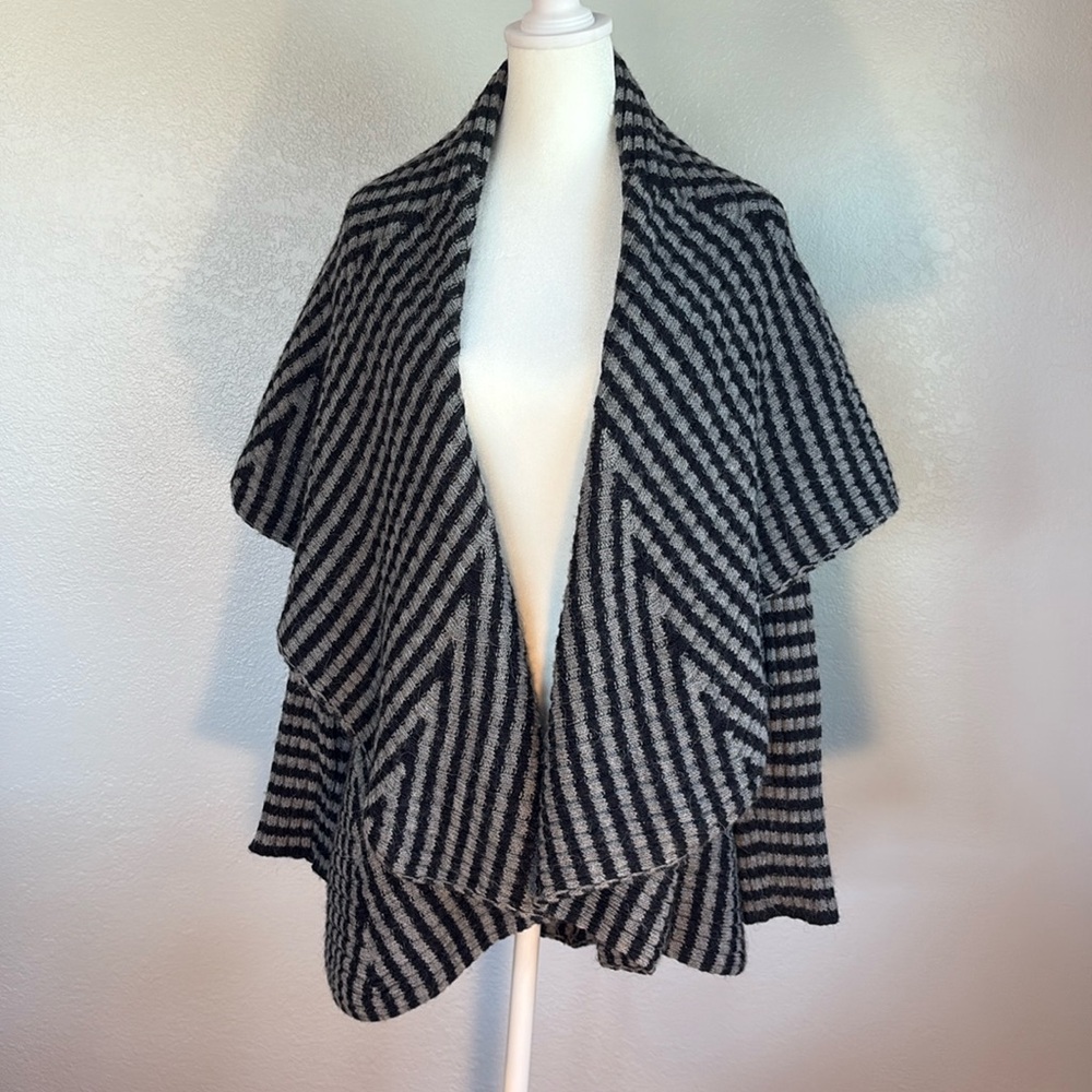 Black and gray striped cardigan with wide collar/lapels.